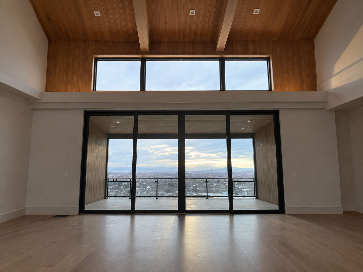 Spacious modern interior with wood beams and mountain views